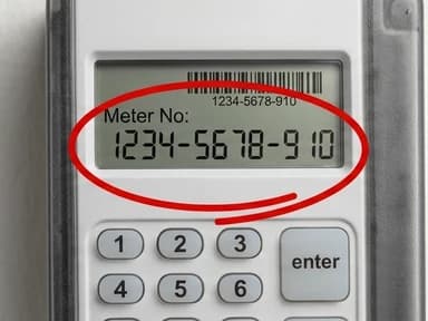 A prepaid meter with the meter number circled on its display